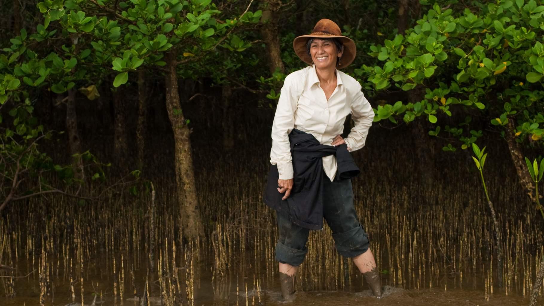 Pew marine fellow Jurgenne Primavera in nearly knee-deep mud at a mangrove site in her native Philippines in 2009—a place she loves and works to protect.  