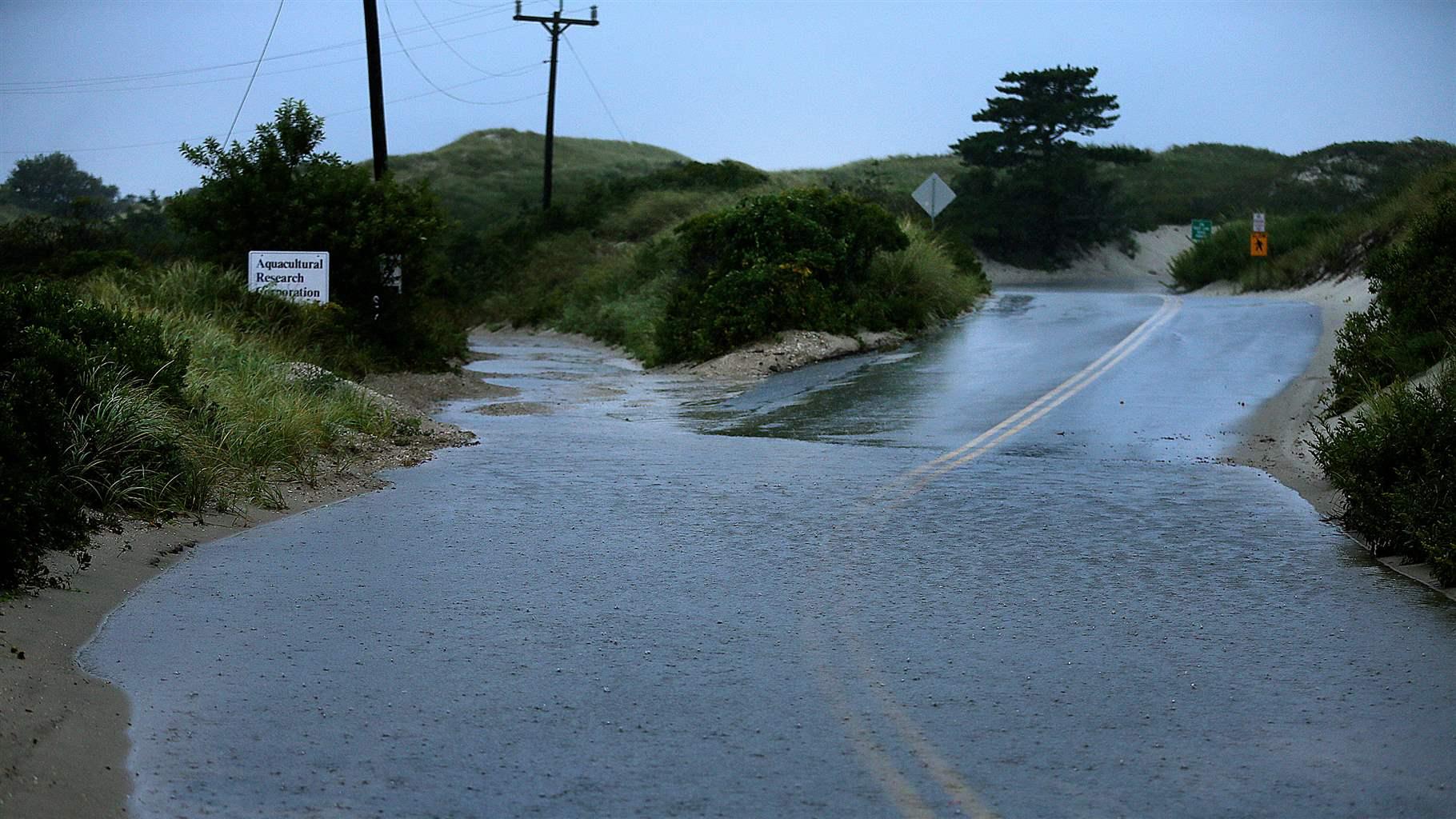 Hurricane Dorian gives a glancing blow to Cape Cod, as high tide in the early morning brings some flooding to Dr. Botello Road leading to Chapin Memorial Beach, right, and the road to the Aquaculture Research Corporation, left, in Dennis, MA on Sep. 7, 2019.
