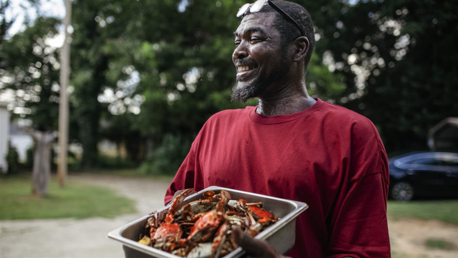 Man with blue crabs