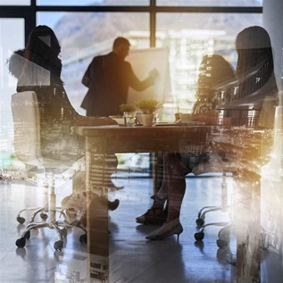 Description Shot of a team brainstorming, business people double exposed with an image of a city