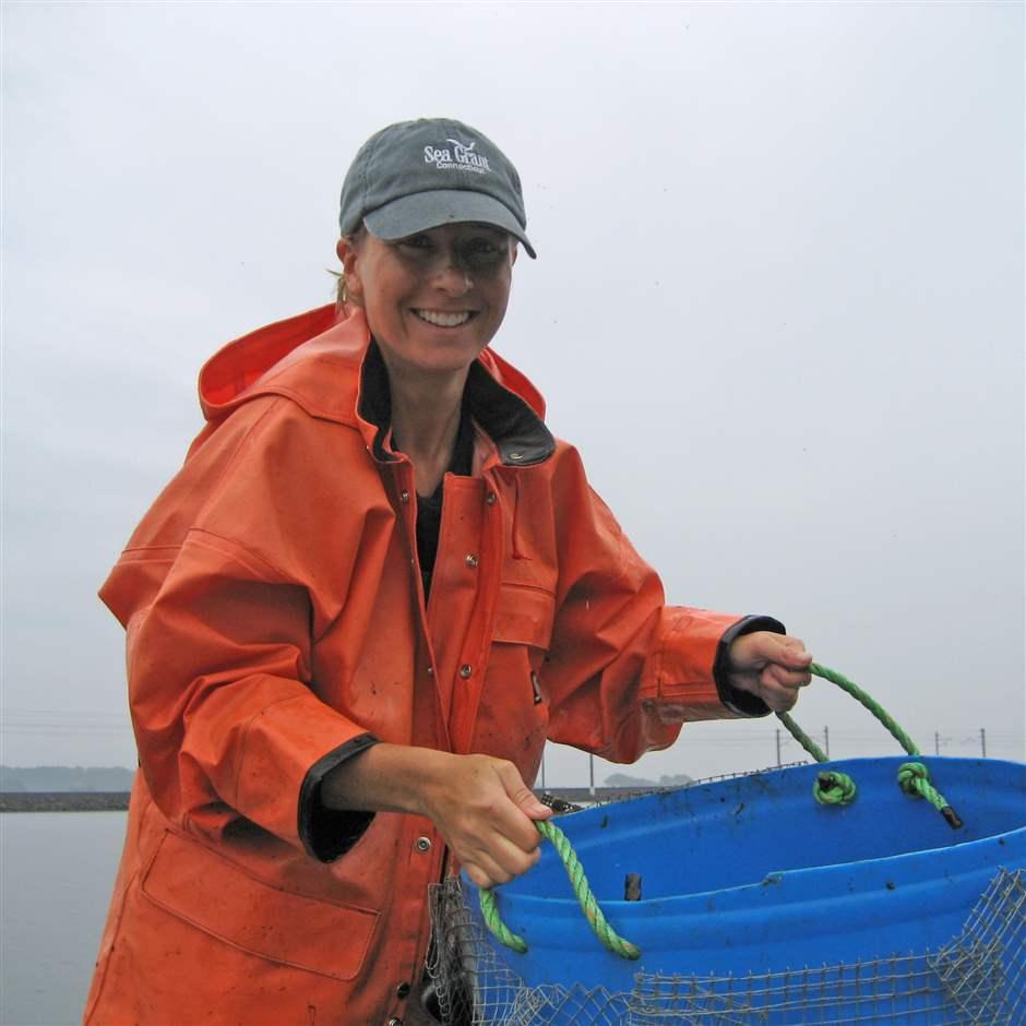 Tessa Getchis, working at an oyster farm in Groton, Connecticut, helped lead the state’s effort to create a mapping tool to support better siting of shellfish restoration projects. 