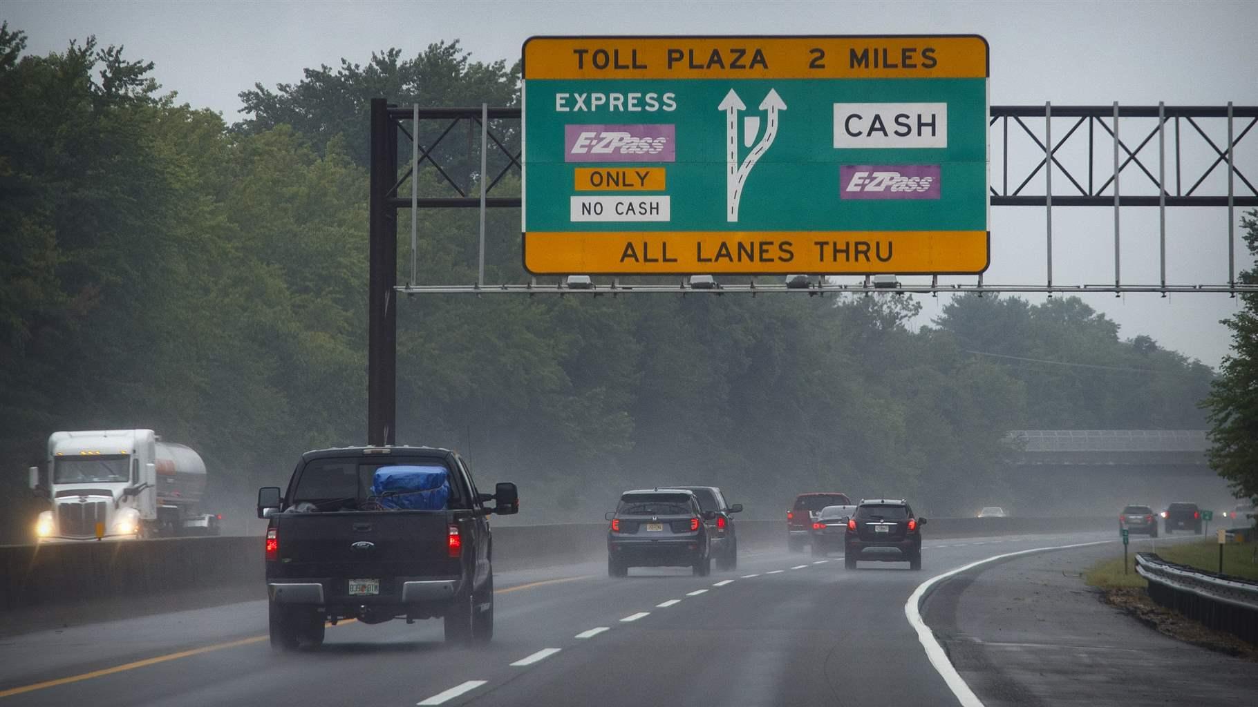 This photo from Friday July 31, 2020, shows toll signage as motorists travel along the New Jersey Turnpike in Carneys Point, N.J.