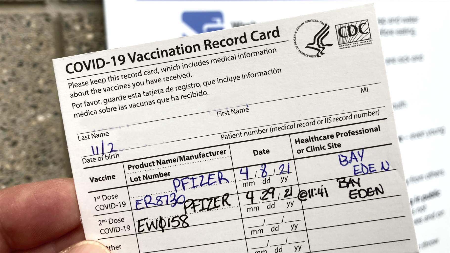 A COVID-19 proof of vaccination card is shown at a Bronx vaccination site in New York City. 