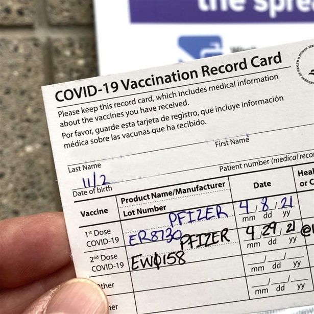 A COVID-19 proof of vaccination card is shown at a Bronx vaccination site in New York City. A COVID-19 proof of vaccination card is shown at a Bronx vaccination site in New York City.