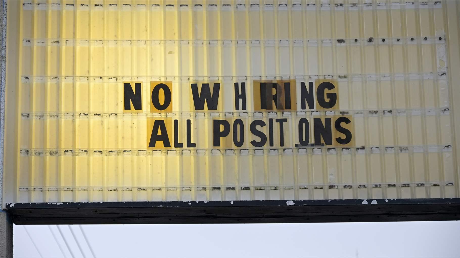A Now Hiring sign advertising job openings is viewed outside a bowling alley during a new coronavirus pandemic, Thursday, July 29, 2021, in Winter Garden, Fla.