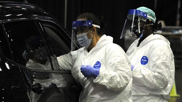 VIRUS OUTBREAK-ALABAMA-YOUNG PEOPLE In this Aug. 12, 2021 file photo, workers from USA Health test a person for COVID-19 during a drive-up clinic in Mobile, Ala. Health officials say they are seeing a spike in cases among young adults and children as the highly contagious delta variant sweeps through unvaccinated populations.