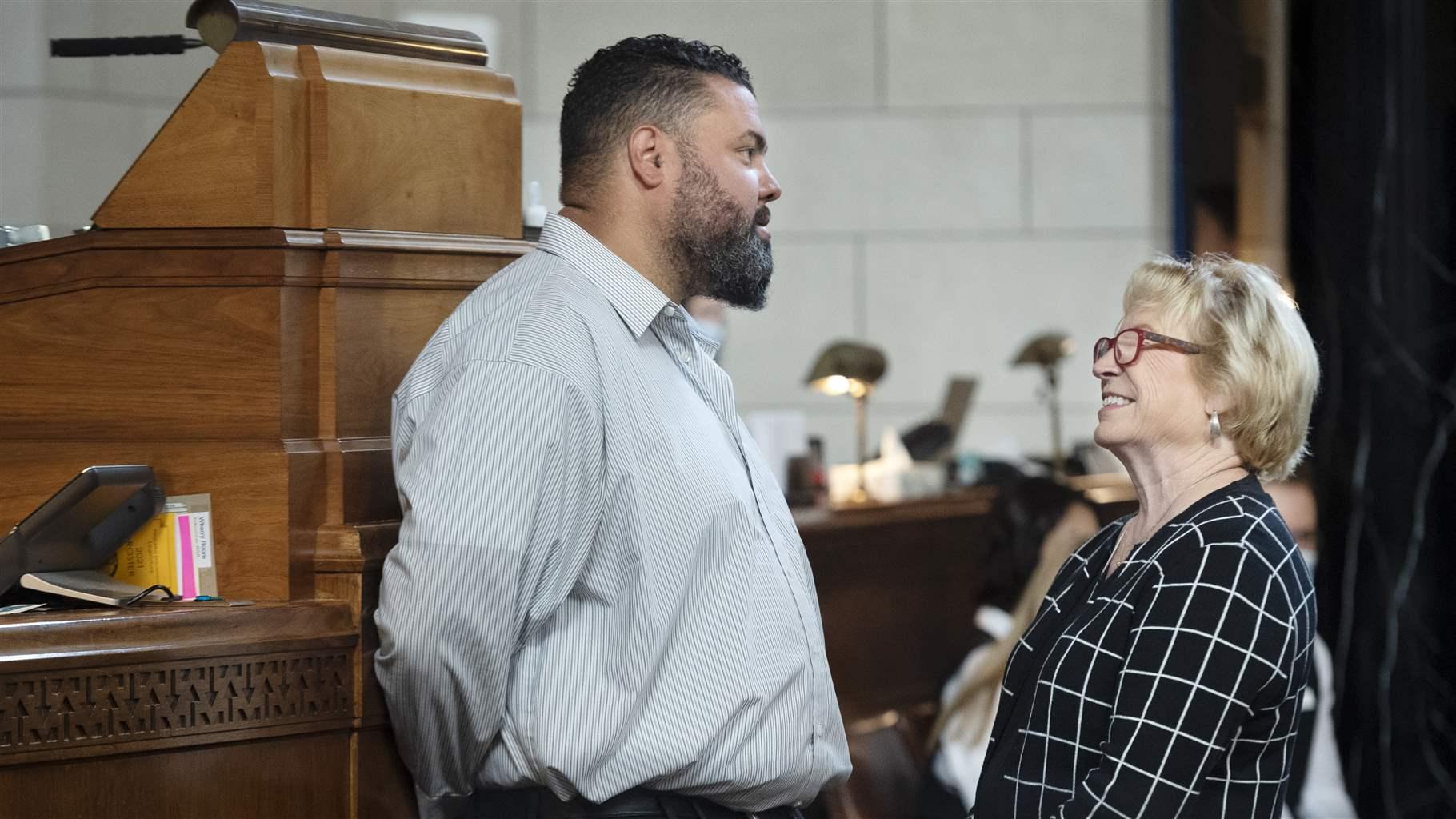 Nebraska state Sen. Justin Wayne talks with Sen. Lou Ann Linehan during the first day of the special session on redistricting, Monday, Sept. 13, 2021, in Lincoln, Neb