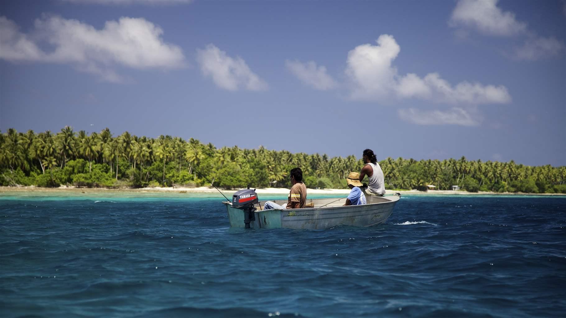 Three fishermen wait patiently for fish off the coast of Majuro in the Marshall Islands.