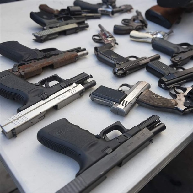 Pistols traded in by people during the annual gun buy-back event hosted by United Playaz are seen on a table in San Francisco, California, United States on December 14, 2019