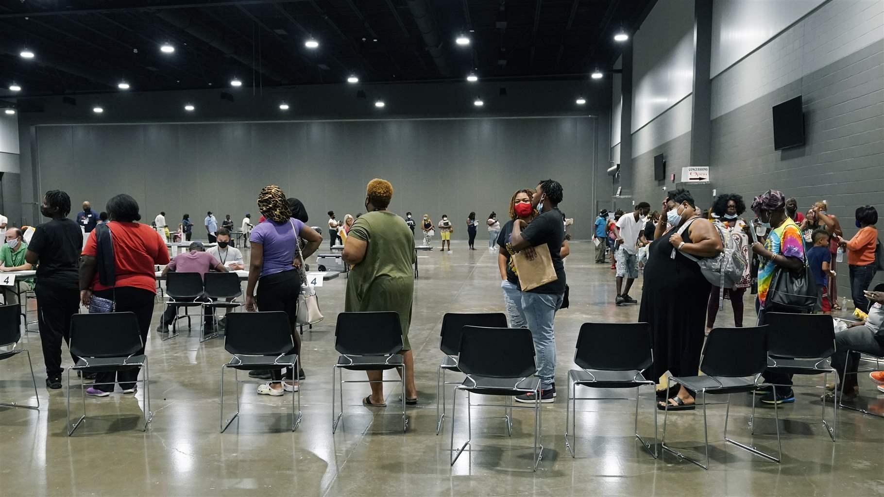 Applicants at a rental assistance fair for Jackson residents at the Mississippi Trademart, line up to be assigned the proper station in the state Fairgrounds, Saturday, July 24, 2021, in Jackson, Miss