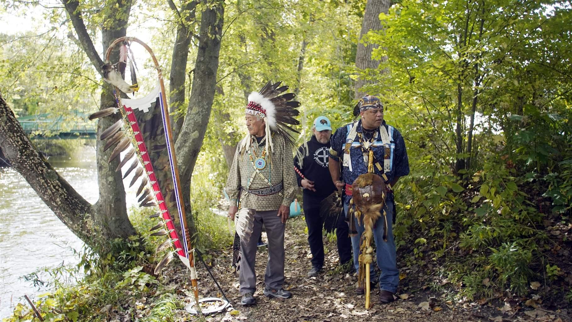 Jake Singer and Shawn Stevens prepare to make offerings to the Housatonic River for the celebration of Indigenous Peoples Day in Great Barrington, Mass., on Monday, Oct. 11, 2021.