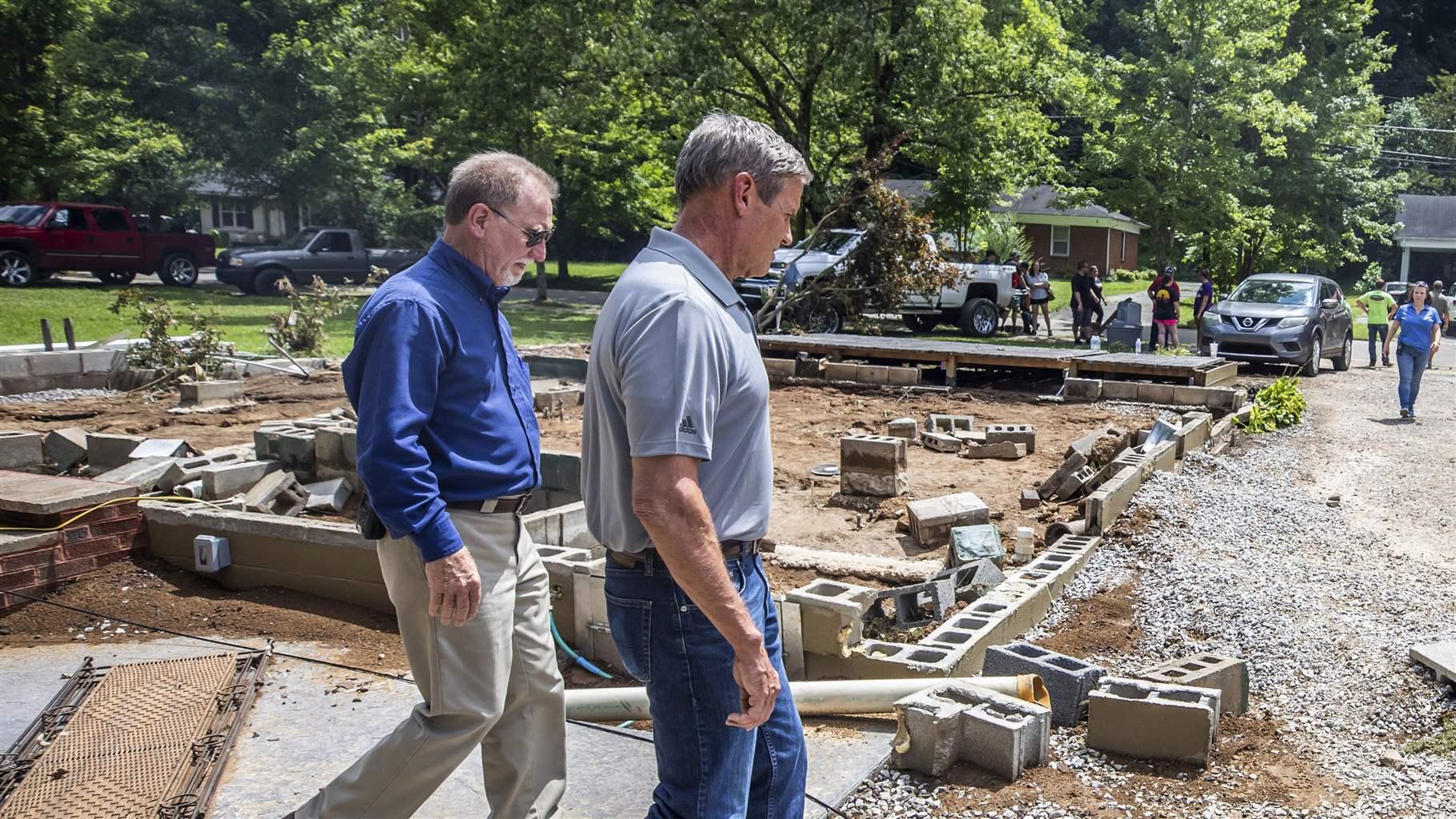 Tennessee Gov. Bill Lee (R) walks past a home swept off its foundation in catastrophic floods August 22, 2021 in Waverly, Tennessee.
