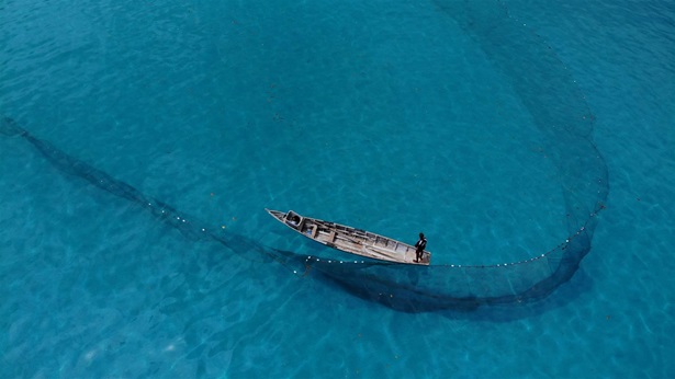 Aerial view of a small boat in the middle of water