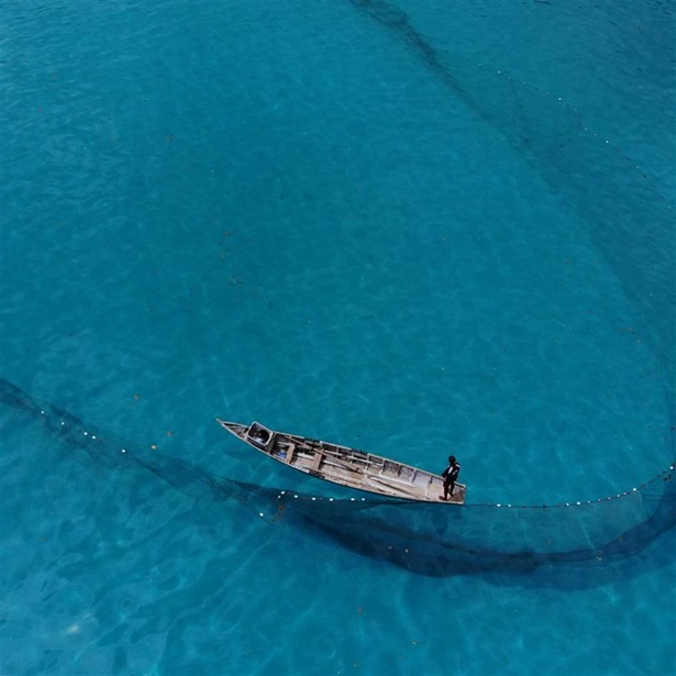 Aerial view of a small boat in the middle of water