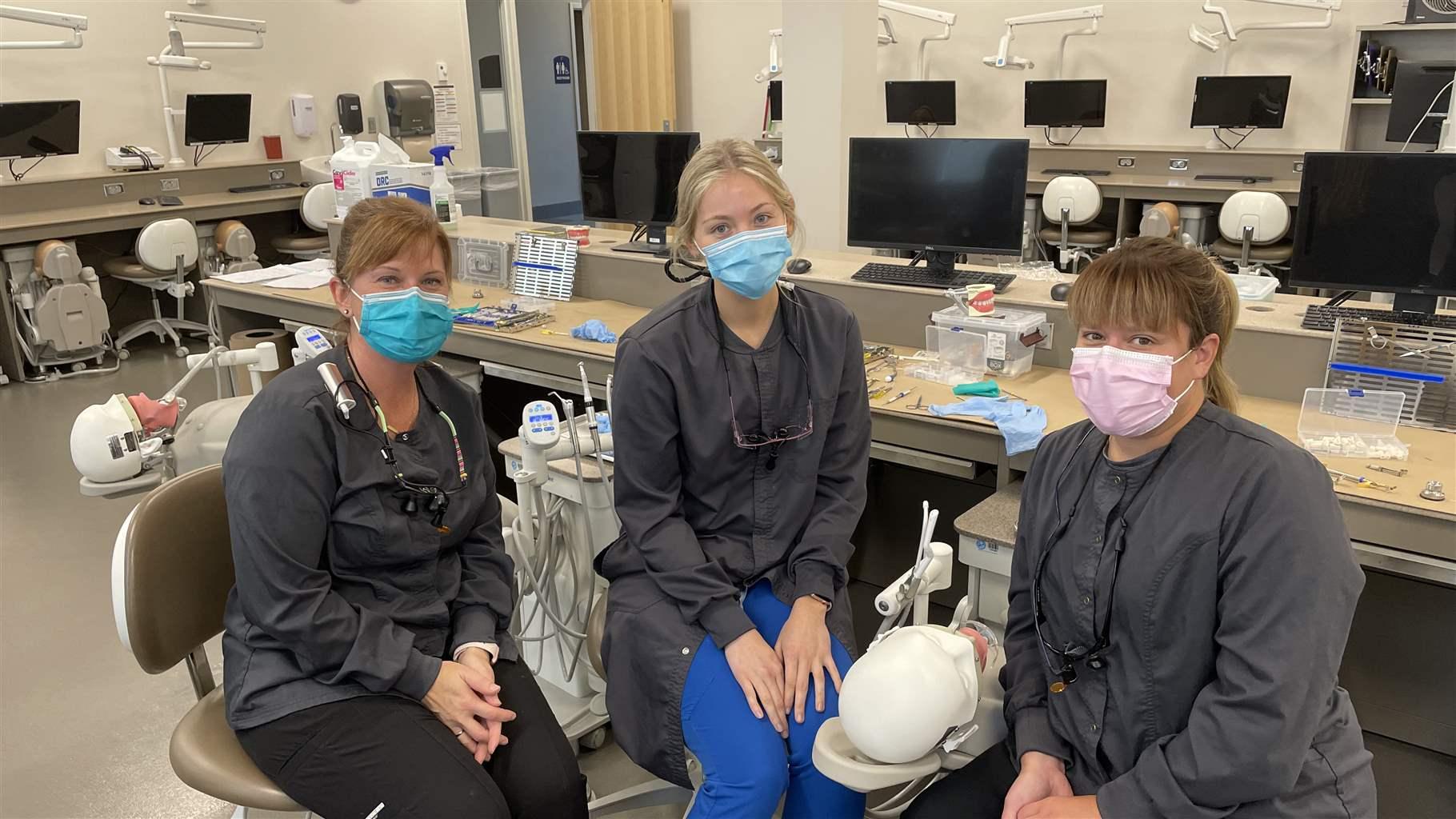 Dental therapy students Amanda Weyek, Rachel Wangen, and Cindy Degner, left to right, in the Minnesota State University-Mankato Dental Simulation Lab.