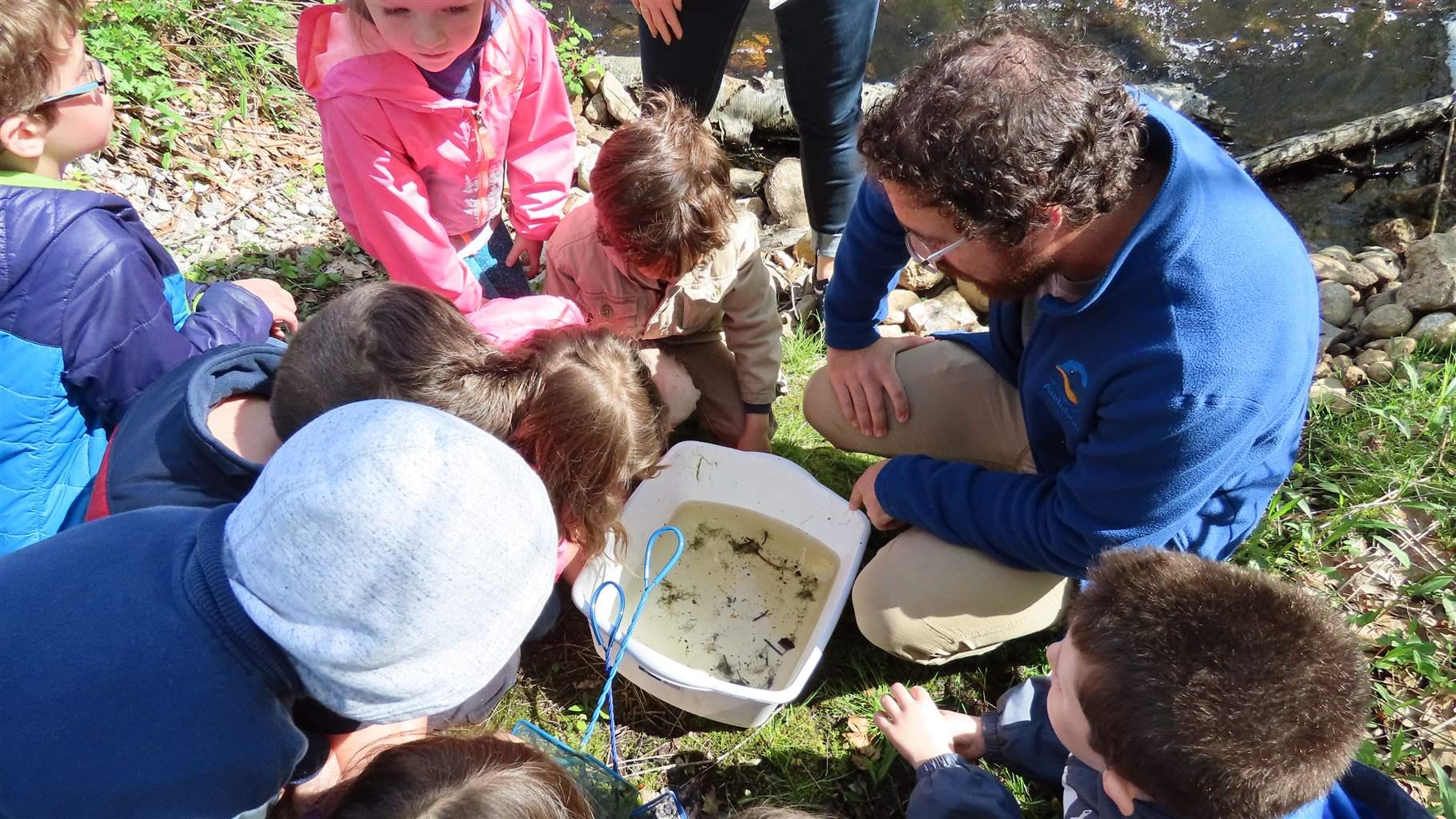 Joe Attwater, a teacher and naturalist with the Roger Tory Peterson Estuary Center in Old Lyme, Connecticut, works with children at the Jewett Preserve, in nearby Lyme. 
