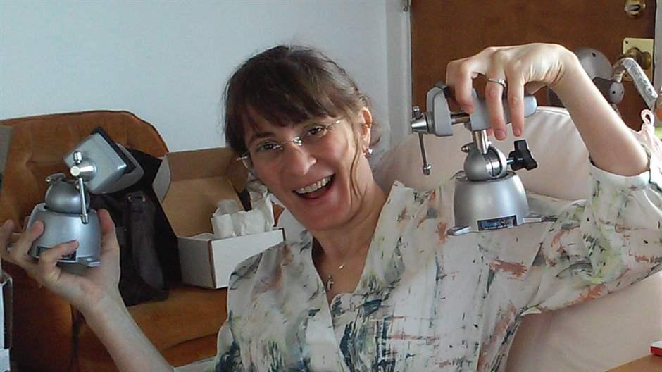 Verónica C. Piatti holds the first lab instruments she purchased with her Pew grant in 2014: mechanical apparatuses to build electrode array ensembles. 