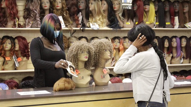 Customer purchasing wig at beauty shop