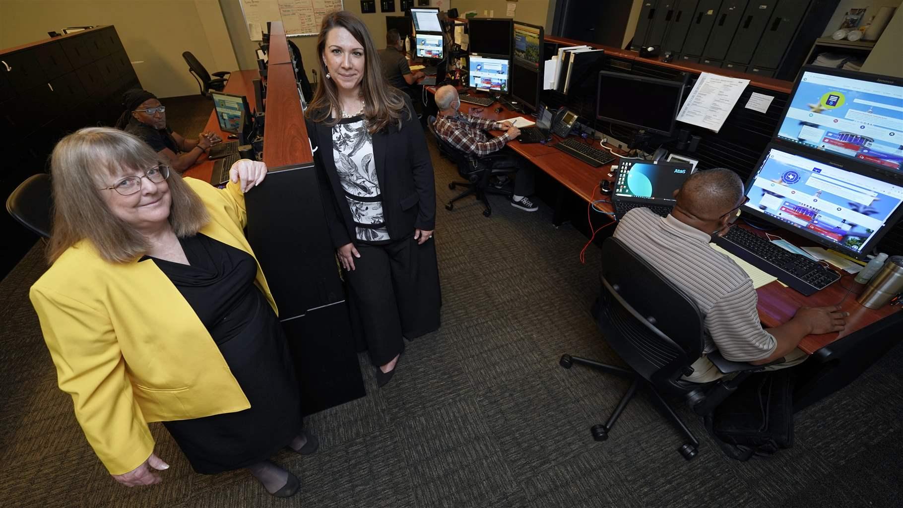 Information Resources Command Center State officials standing inside the Texas Department of Information Resources command center in July.