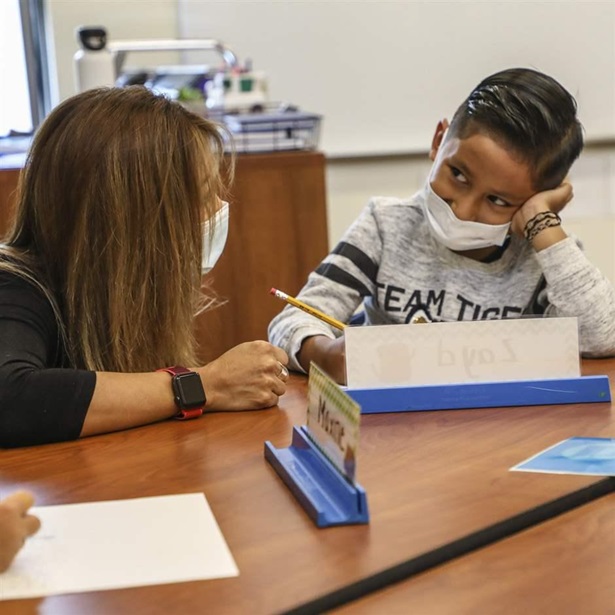 First-grade teacher Monica Moreno and Zayd Hernandez work on an assignment the first day of school at Homestake Peak School Monday, Aug. 16, in Eagle Vail, Colo.