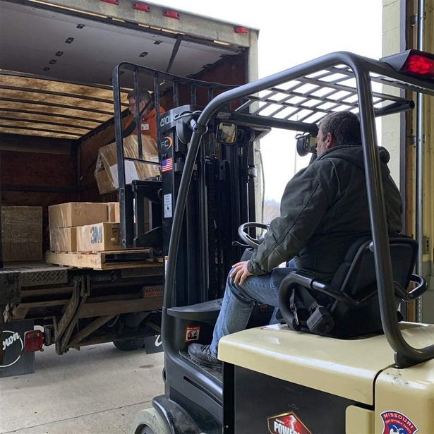 Loading supplies into truck Loading supplies into truck