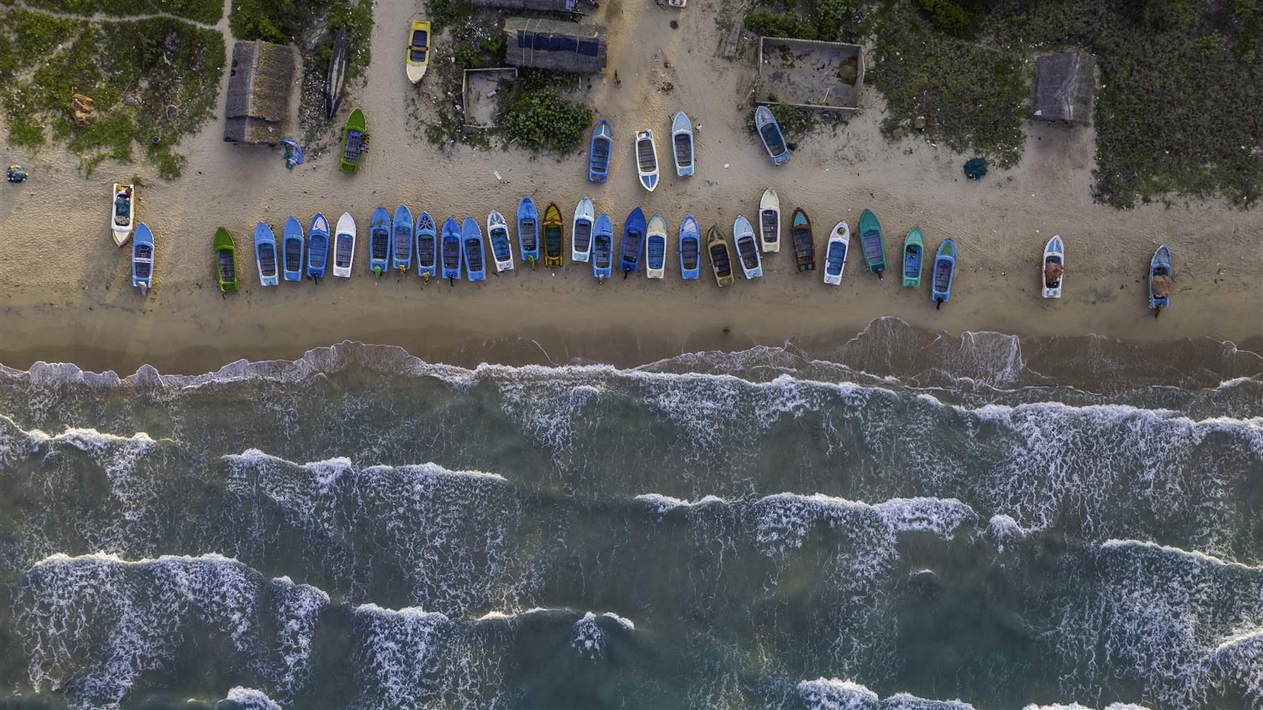 Aerial view of the fishing boats on the beach in a small coastal village near Trincomalee, Sri Lanka.