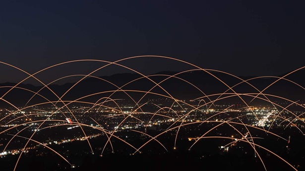 Networks of communication and fiber-optics over city skyline