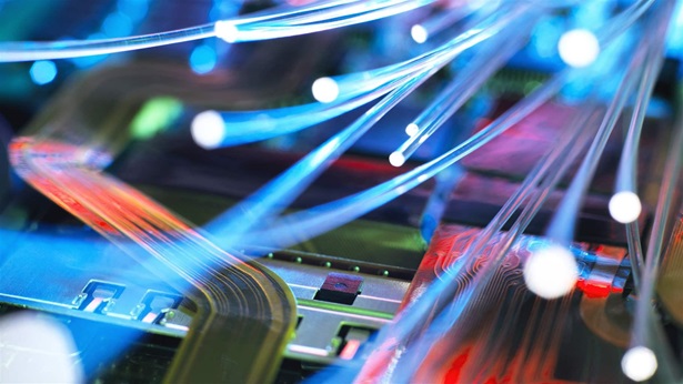 Fibre optic strands carrying data over electronic circuit board of laptop computer Fibre optic strands carrying data over electronic circuit board of laptop computer