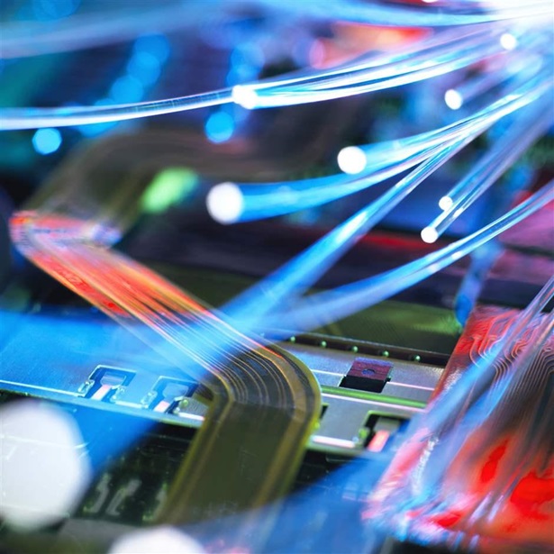Fibre optic strands carrying data over electronic circuit board of laptop computer Fibre optic strands carrying data over electronic circuit board of laptop computer