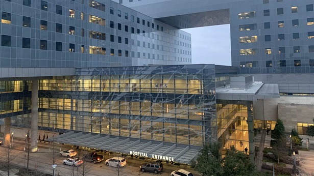 Landscape view of the front entrance of Parkland Health & Hospital System in Dallas in the evening hour