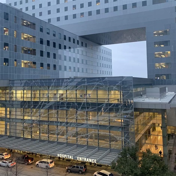 Landscape view of the front entrance of Parkland Health & Hospital System in Dallas in the evening hour