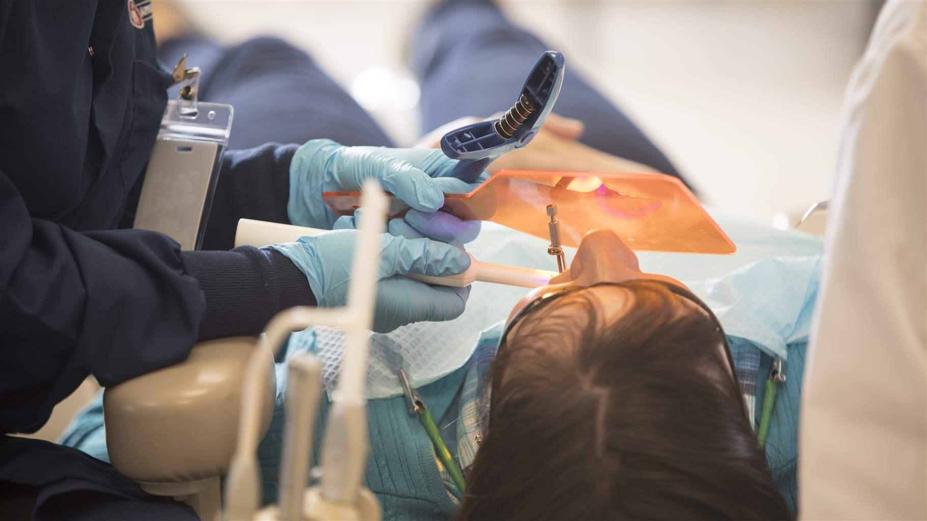 Heather Luebben, a dental therapist from Apple Tree Dental performs dental treatments through their mobile clinic at Options, Inc. in Big Lake, Minn., on April 13, 2017.