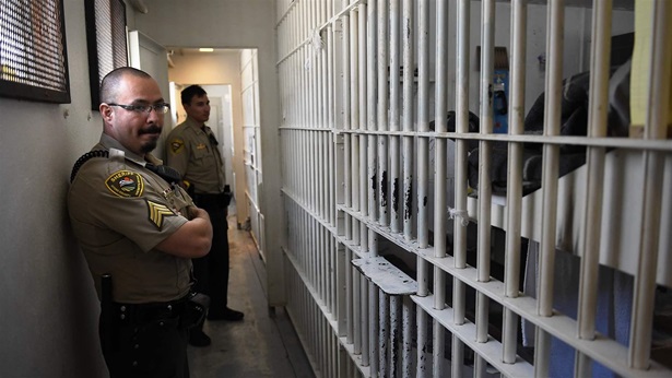 Officer standing by jail cells