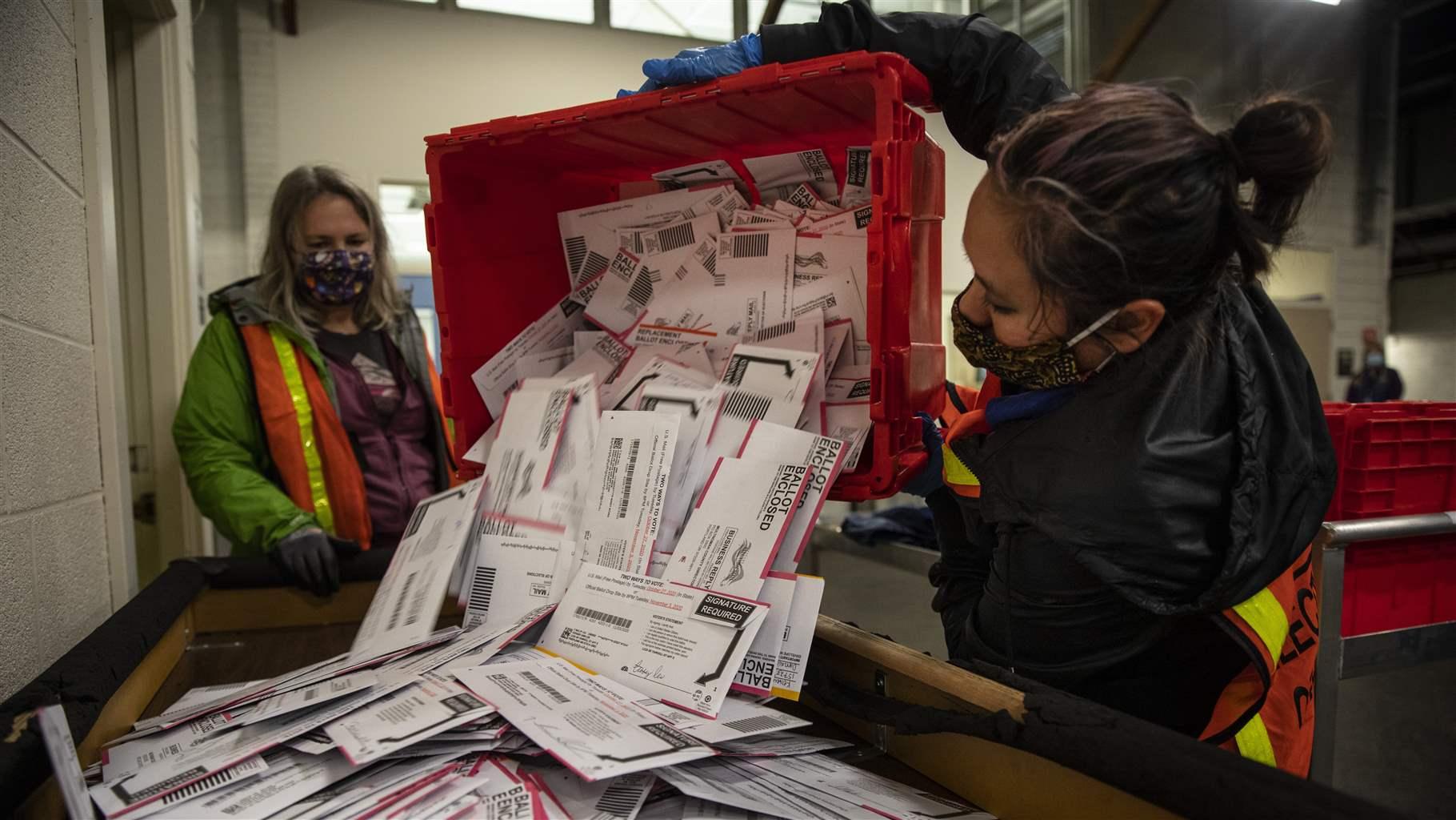 election workers process mail-in ballots election workers process mail-in ballots
