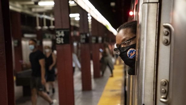 Desmond Hill, a vaccinated MTA conductor, looks out his crew cab window to check the platform for late-arriving passengers as he works the N subway line from Brooklyn's Coney Island to Queen's Astoria-Ditmars neighborhoods, Friday, Aug. 13, 2021, in New York. Desmond Hill, a vaccinated MTA conductor, looks out his crew cab window to check the platform for late-arriving passengers as he works the N subway line from Brooklyn's Coney Island to Queen's Astoria-Ditmars neighborhoods, Friday, Aug. 13, 2021, in New York.