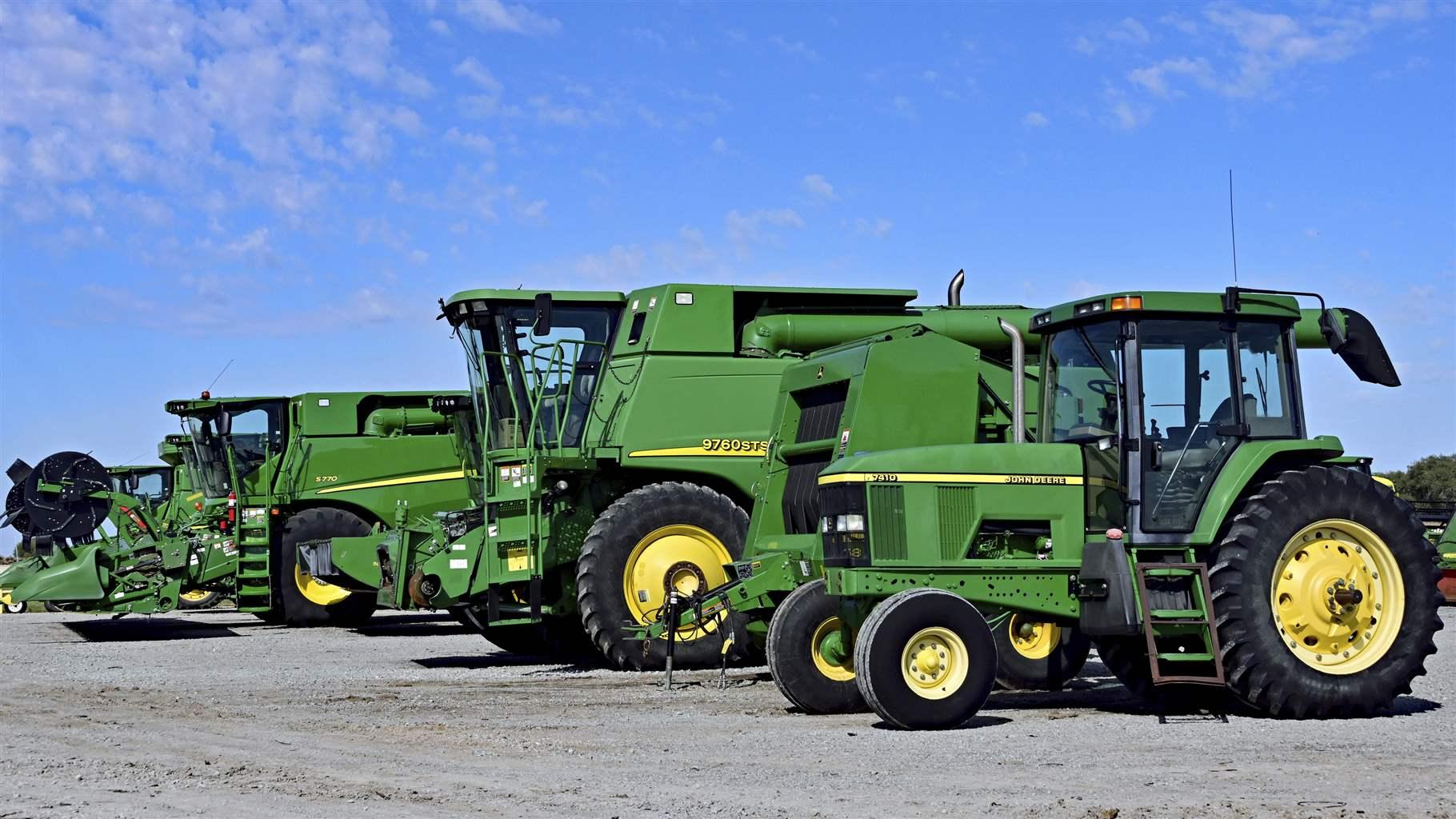 Brand new farm machinery, including tractors, combines, balers, cutter heads lined up for sale outside Prairieland Partners John Deere dealership during the first strike by John Deere workers in 35 years in Emporia, Kansas on October 14, 2021.