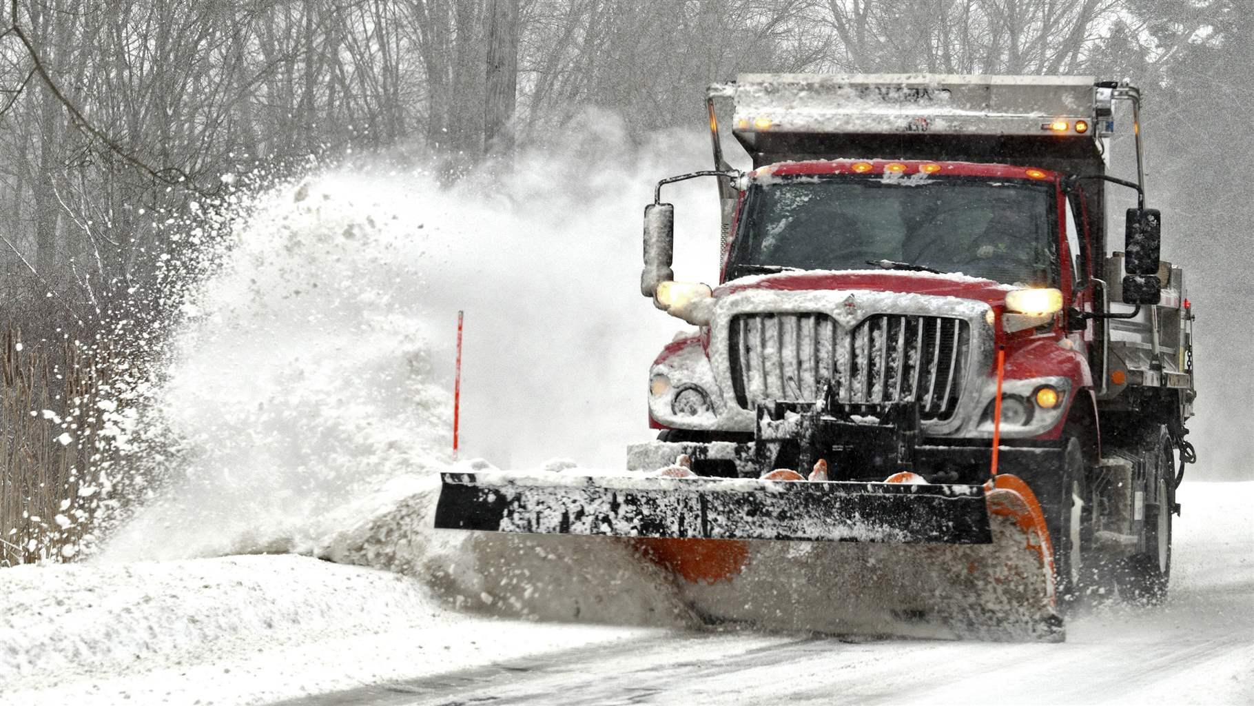A snow plows work along Route 307 on Thursday afternoon, Feb. 3, 2022, as snow falls in Jefferson, Ohio.