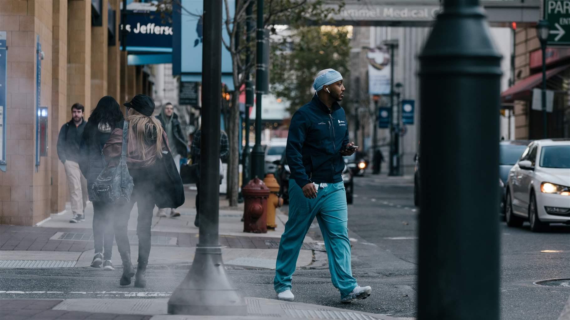 Commuters and medical professionals walk near Thomas Jefferson University Hospital in Philadelphia, Pa., on Nov. 8, 2019.