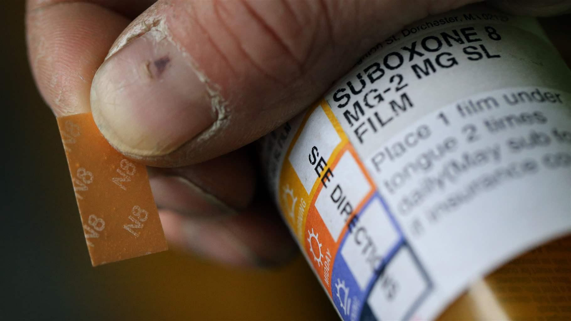 A patient displays his Suboxone prescription following his appointment at the Substance Use Disorders Bridge Clinic at Massachusetts General Hospital in Boston on April 27, 2018. 