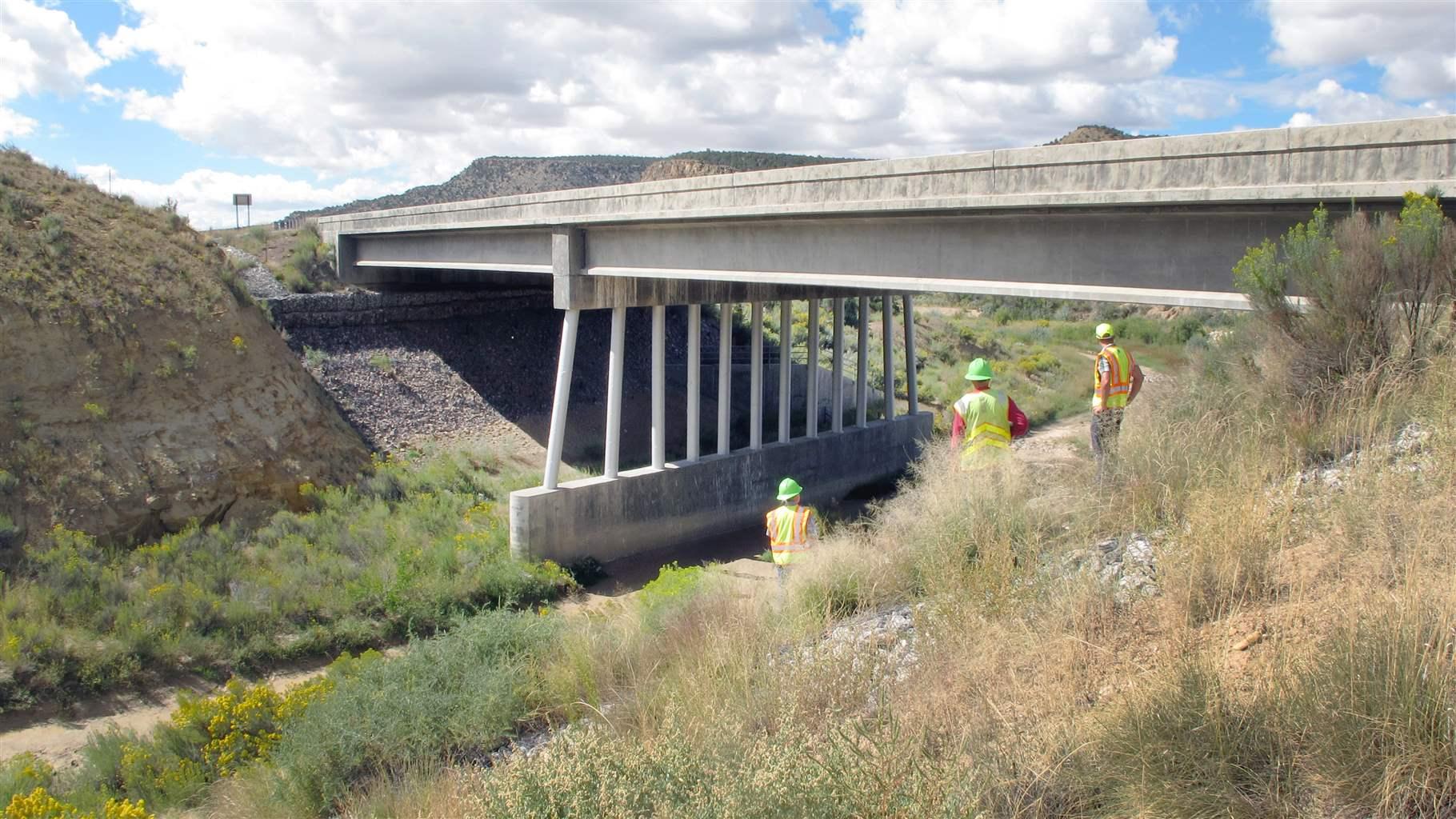 NMDOT employees inspect a bridge over the Rio Puerco built in 2019. U.S. Highway 550 south of Cuba is an area that state officials identified as a high wildlife-vehicle collision hotspot.