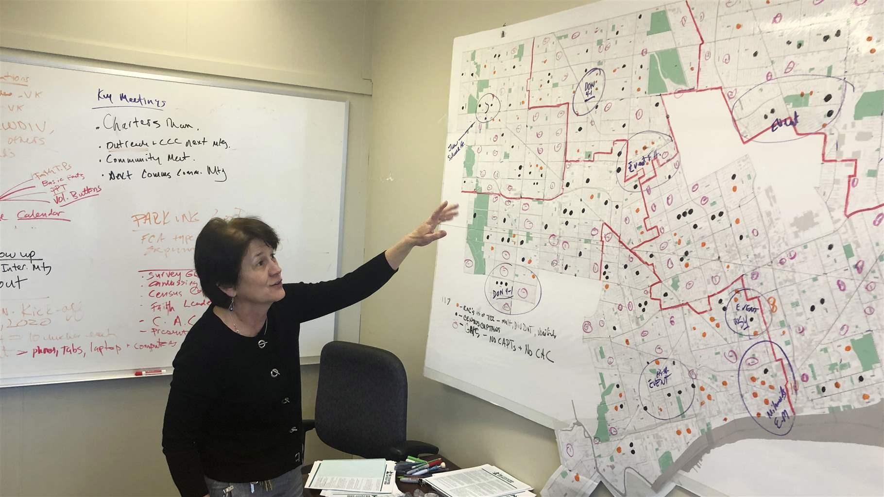 In this Nov. 22, 2019 file photo, Detroit 2020 Census Campaign executive director Victoria Kovari looks over a Detroit map showing city neighborhoods that were under-counted in the 2010 census. In this Nov. 22, 2019 file photo, Detroit 2020 Census Campaign executive director Victoria Kovari looks over a Detroit map showing city neighborhoods that were under-counted in the 2010 census.