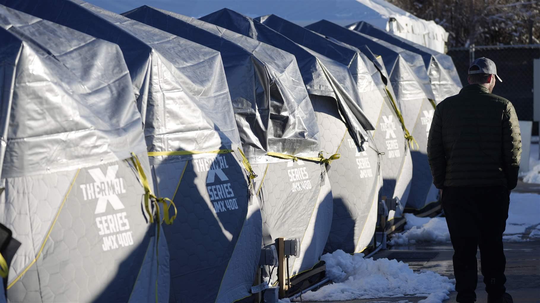 HOMELESS ICE FISHING TENTS Tents stand in a long row at the east safe outdoor space in the parking lot of the city of Denver Human Service building in Denver on Thursday, Feb. 17, 2022. The safe space is home to more than 150 people.