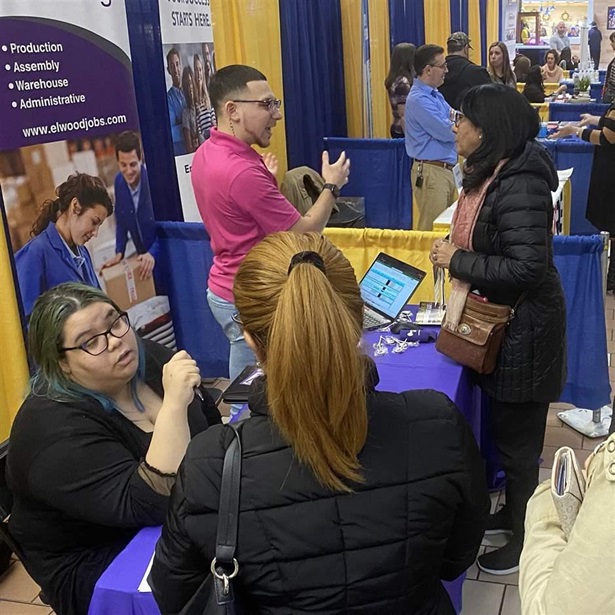 Angelica Vidal, seated on left, and Joel Medina, of Elwood Staffing, talk to job seekers about some of the 70-80 jobs they are looking to fill during the 26th Annual Greater Hazleton Job Fair held at the Laurel Mall in Hazleton, Pa., on March 24, 2022.