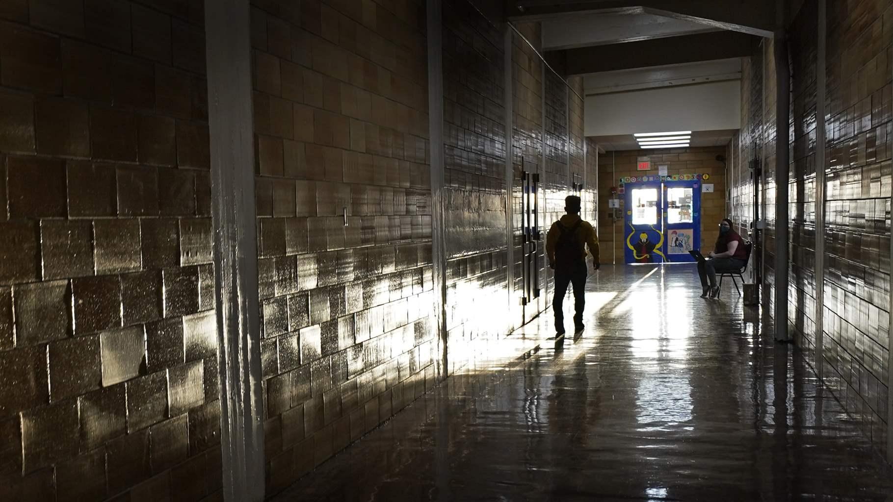 student walks down a hallway student walks down a hallway