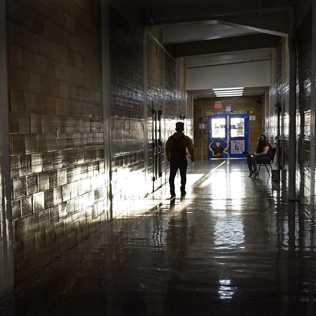 student walks down a hallway