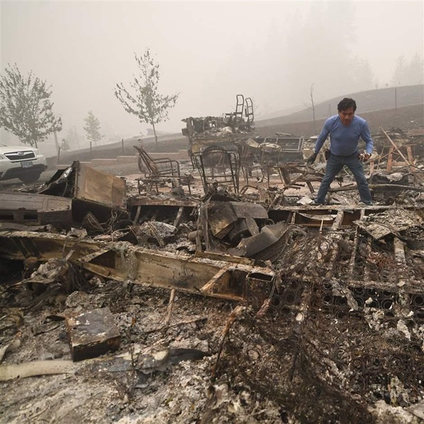 Marcelino Maceda looks for items in the remains of his mobile home after a wildfire sweep through the R.V. park destroying multiple homes in Estacada, Oregon September 12, 2020. - US officials girded today for the possibility of mass fatalities from raging wildfires up and down the West Coast, as evacuees recounted the pain of leaving everything behind in the face of fast-moving flames. Dense smog from US wildfires that have burnt nearly five million acres and killed 27 people smothered the West Coast on September 12. 