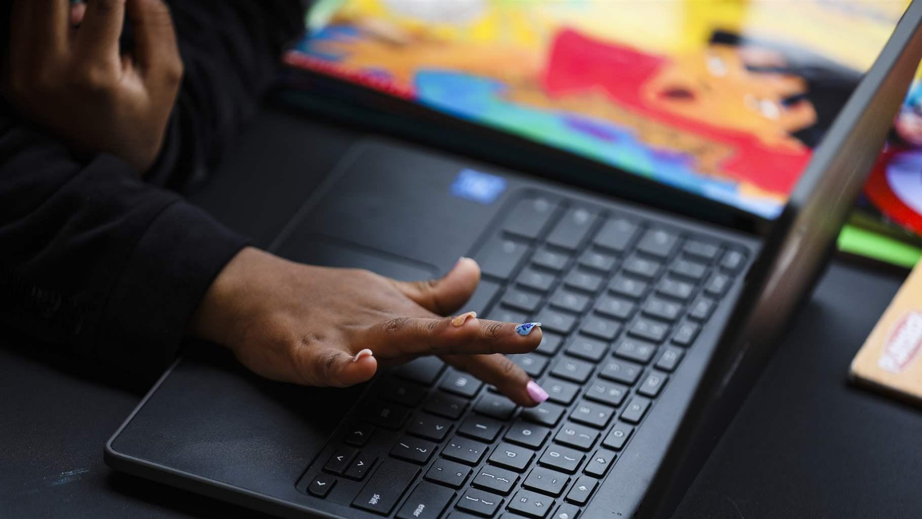 A child learns how to find a letter on a keyboard on a computer in Boston on April 8, 2021.