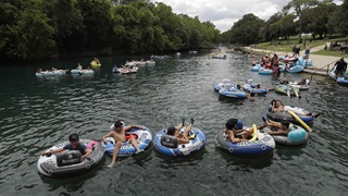Tubers float the Comal River despite the recent spike in COVID-19 cases, Thursday, June 25, 2020, in New Braunfels, Texas. Texas Gov. Greg Abbott said Wednesday that the state is facing a "massive outbreak" in the coronavirus pandemic and that some new local restrictions may be needed to protect hospital space for new patients. 