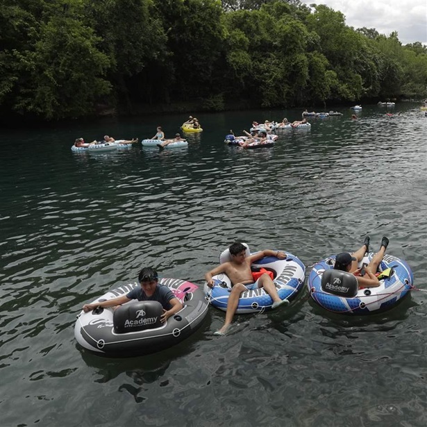 Tubers float the Comal River despite the recent spike in COVID-19 cases, Thursday, June 25, 2020, in New Braunfels, Texas. Texas Gov. Greg Abbott said Wednesday that the state is facing a "massive outbreak" in the coronavirus pandemic and that some new local restrictions may be needed to protect hospital space for new patients. Tubers float the Comal River despite the recent spike in COVID-19 cases, Thursday, June 25, 2020, in New Braunfels, Texas. Texas Gov. Greg Abbott said Wednesday that the state is facing a "massive outbreak" in the coronavirus pandemic and that some new local restrictions may be needed to protect hospital space for new patients.