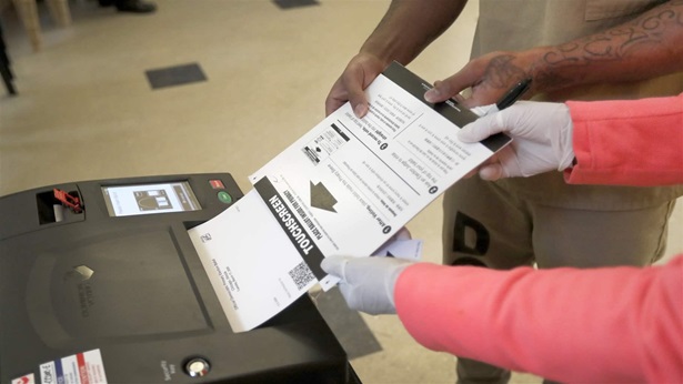In this Saturday, March 14, 2020 file photo, a Cook County jail inmate cast his ballot as he participates in early voting for the March 17, Illinois primary at the jail in Chicago. 